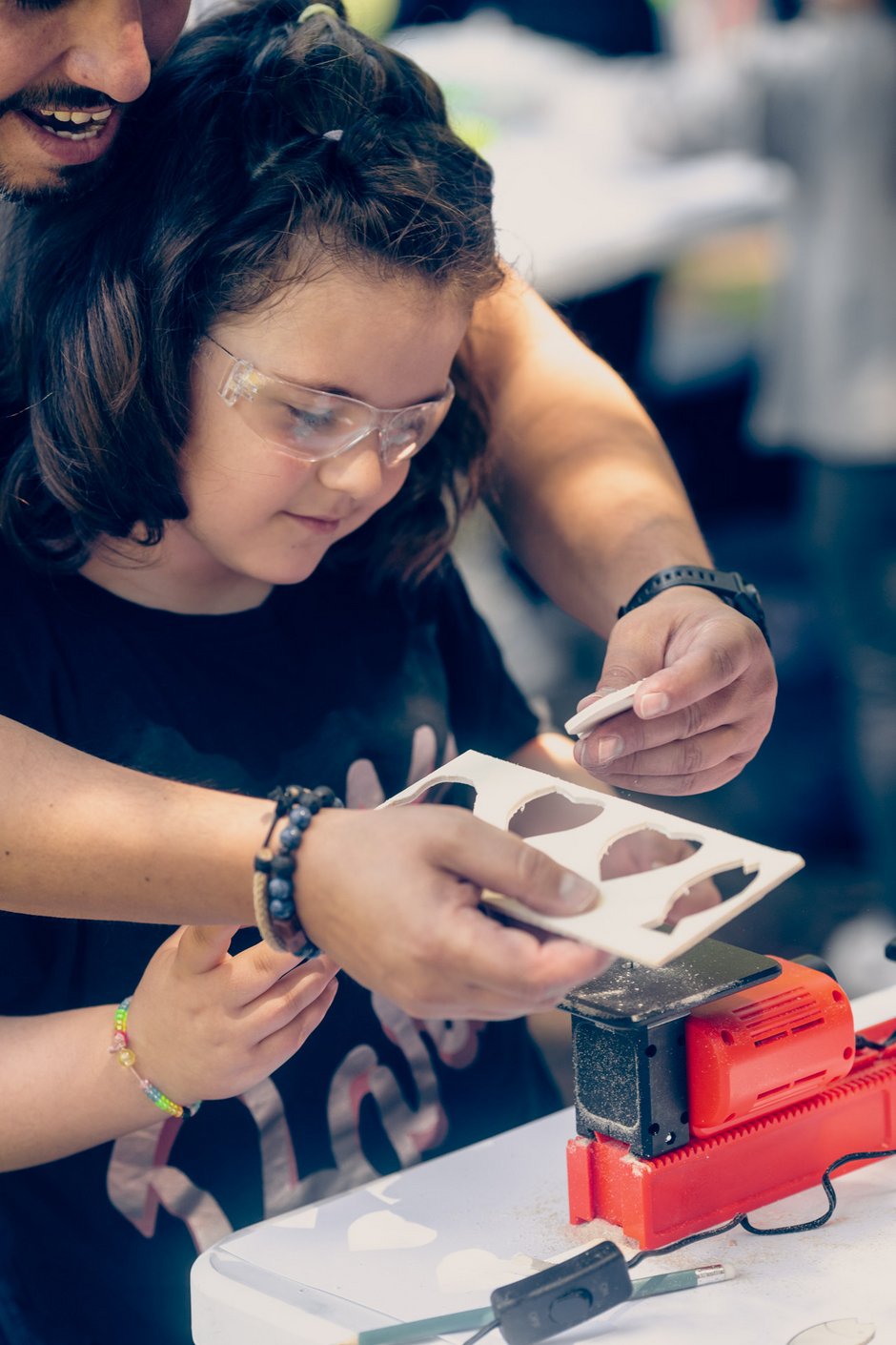 child with parent working on the playmake jig saw